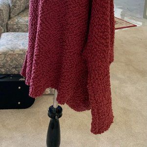 a dark rose colored womans sweater